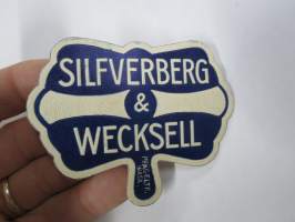 Silverberg & Wecksell -hintalappu / tuotetietolappu, merkin valmistaja Herman Mattsson Korkokuvapaino & Pussitehdas, Vaasa