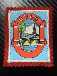 Oulu -kangasmerkki / matkailumerkki / hihamerkki / badge -pohjaväri punainen